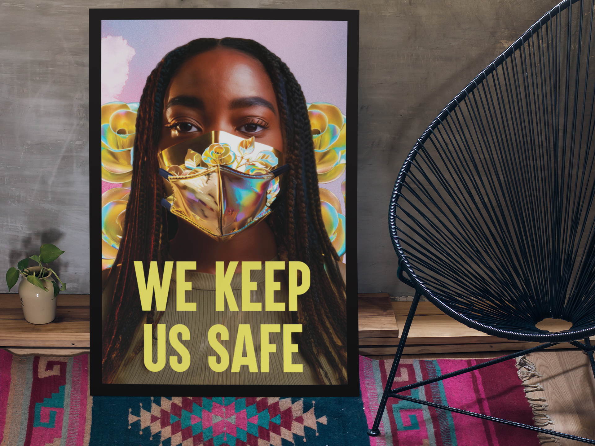 The Limited Edition "We Keep Us Safe" Poster from Disability Culture Lab showcases a woman in a vibrant-patterned face mask leaning against the wall. Underneath her, the phrase "WE KEEP US SAFE" is prominently featured. Nearby, a modern chair and potted plant sit on a colorful rug, all rendered on premium Cold Press Watercolor Paper through the Disability Culture Lab collaboration.